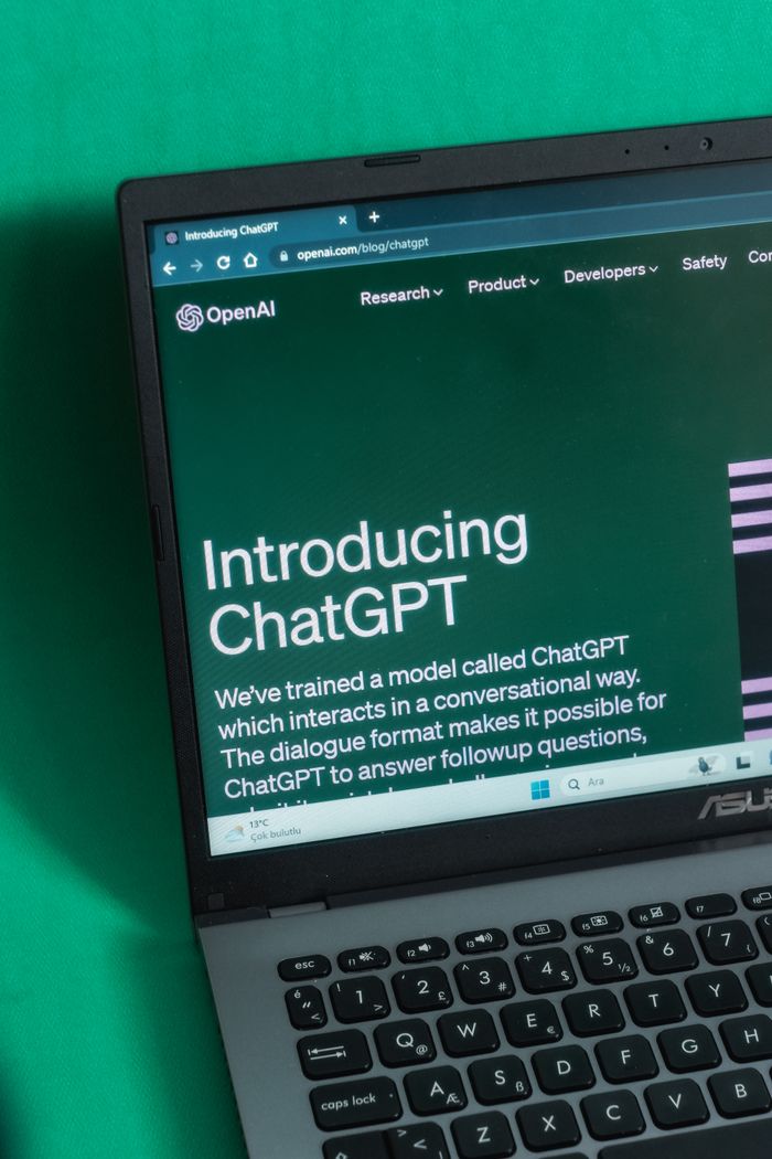 Laptop screen displaying the introductory page of ChatGPT on OpenAIs website.
